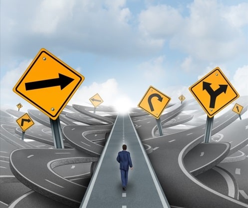 A person walks on a straight road, simulating the guidance that ANI provides to the user in pointing out the best path to follow on the web. Around them are many other roads and signs that are much more complicated to navigate.